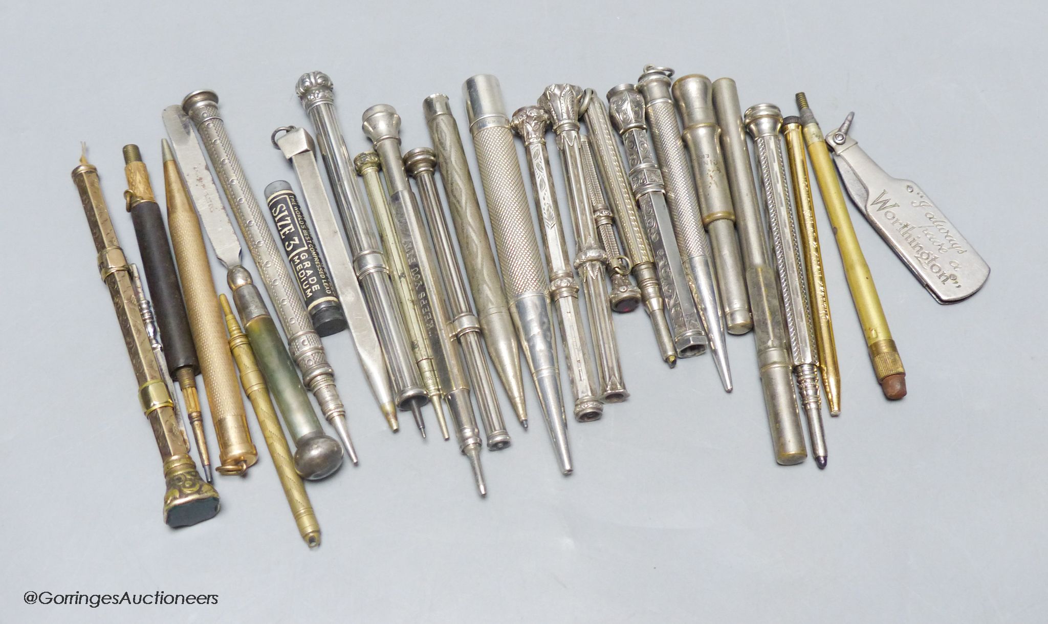 A group of silver and metal propelling pencils
